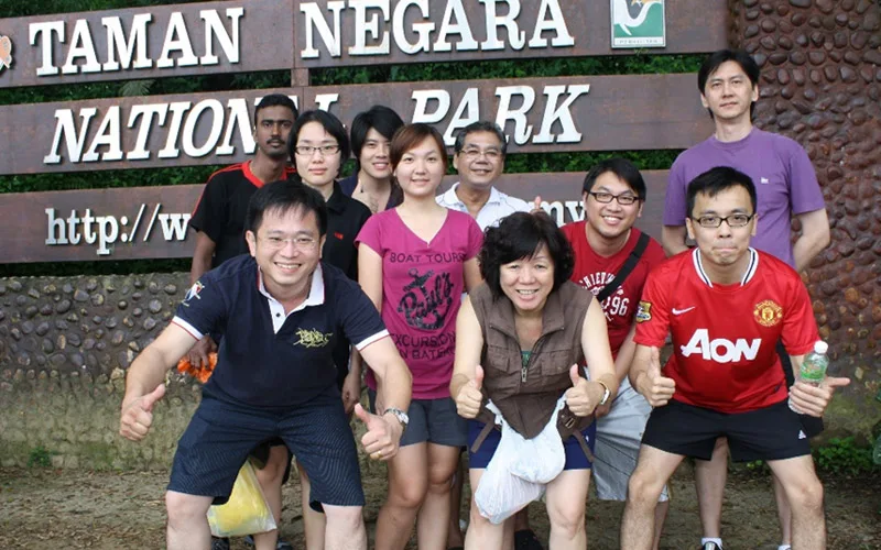 A cheering group behind an ABB team building banner