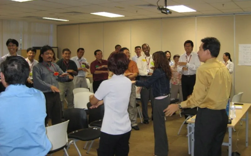 A facilitated session with participants standing in discussion