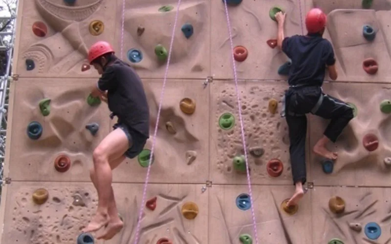 A participant climbing a rock wall