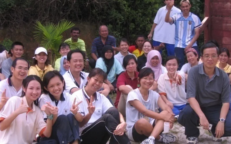 Road Builder staff gathered for a group photo outdoors on a hillside
