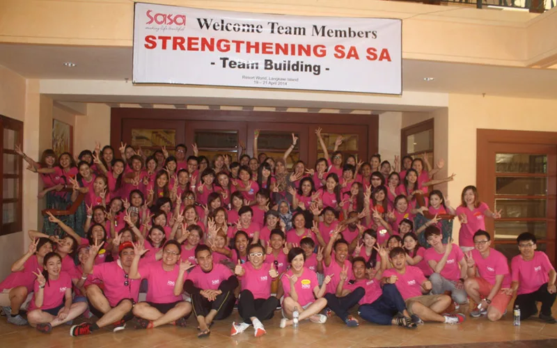 A large group in pink shirts at a strengthening programme