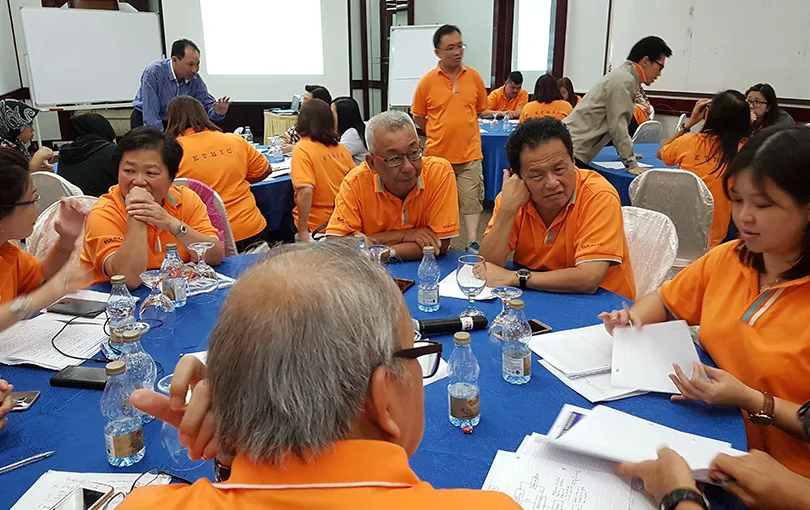 Leaders reviewing documents around a planning table