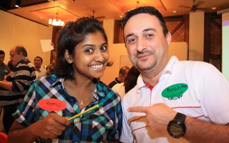 Two participants laughing during a QOM team bonding activity